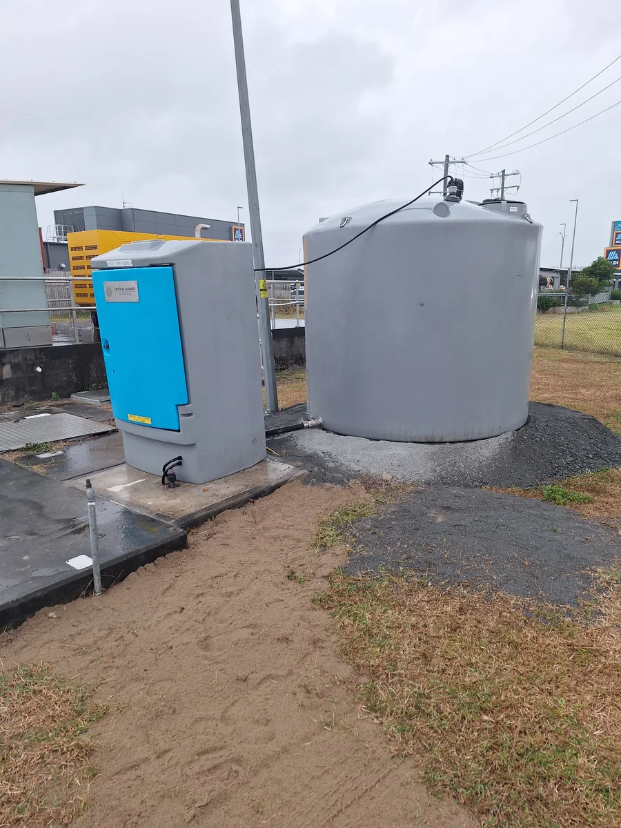 Outdoor chemical dosing cabinet and storage tank at a field installation