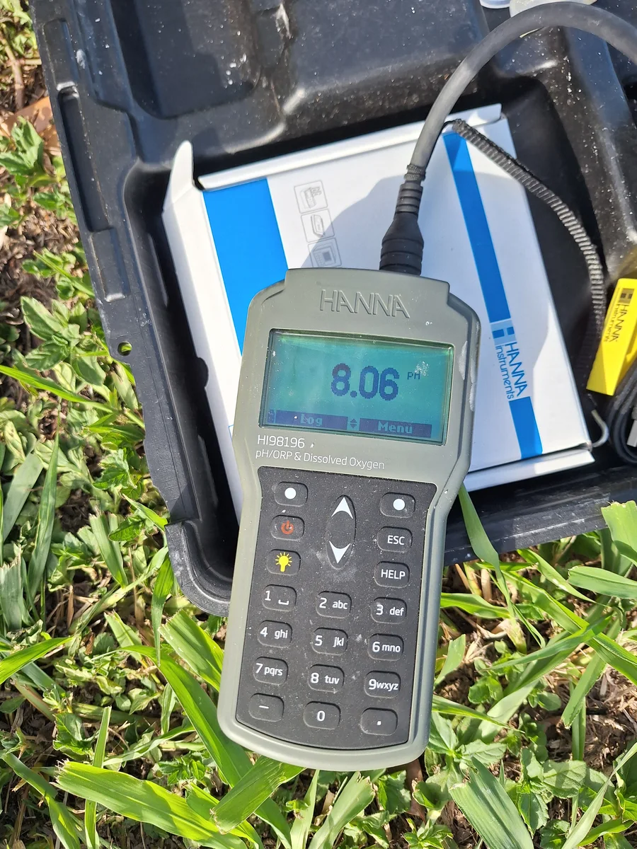 Portable meter displaying a field pH measurement