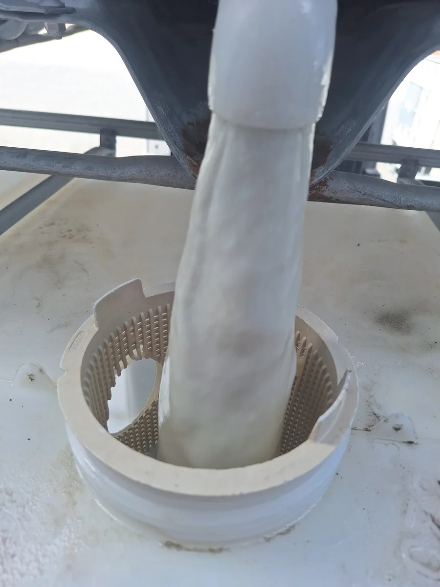 Liquid being transferred through a filling opening into a storage tank